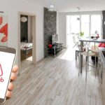 Person holding phone with AirBnB app in condo living area