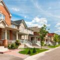Row of suburban Alberta homes under clear skies