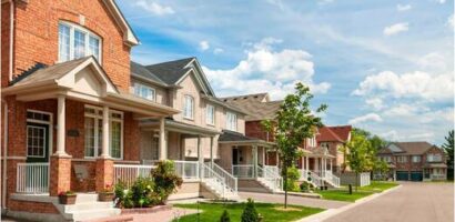 Row of suburban Alberta homes under clear skies