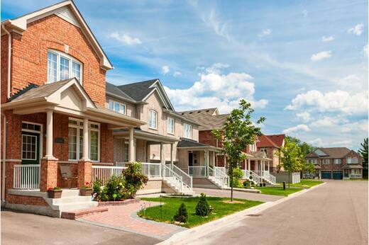 Row of suburban Alberta homes under clear skies
