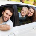 Family sitting in the car looking out windows