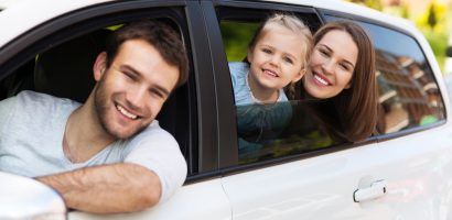 Family sitting in the car looking out windows