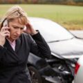 Worried driver on the phone after a car accident