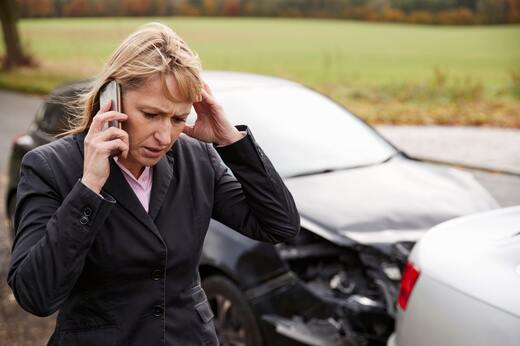 Worried driver on the phone after a car accident