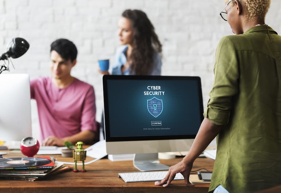 lady looking at computer showing a cyber security confirmation page