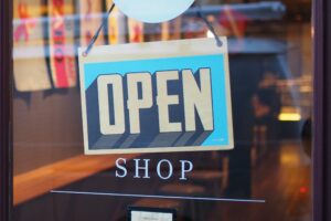 Blue and white open sign in shop window