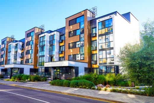 Modern apartment building exterior along a city street