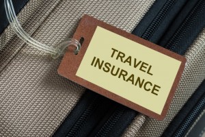Travel insurance tag tied to a luggage