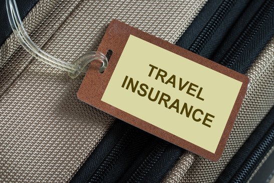 Travel-insurance-tag-tied-to-a-luggage