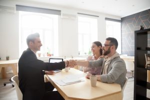 tenant insurance agent congratulating couple after securing their rent insurance